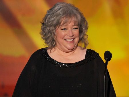 Kathy Bates, who underwent double mastectomy after breast cancer diagnosis, in front of a microphone.