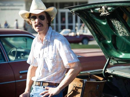 Matthew McConaughey in his role of Ron Woodroof in "Dallas Buyers Club.' Matthew sports a cowboy had a sunglasses. He looks lean and also has a mustache.