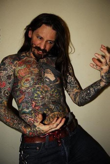 Oliver Peck shows off his full body tattoo.