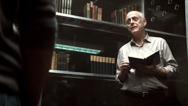 young joe with mooney in the cage, mooney holding a book