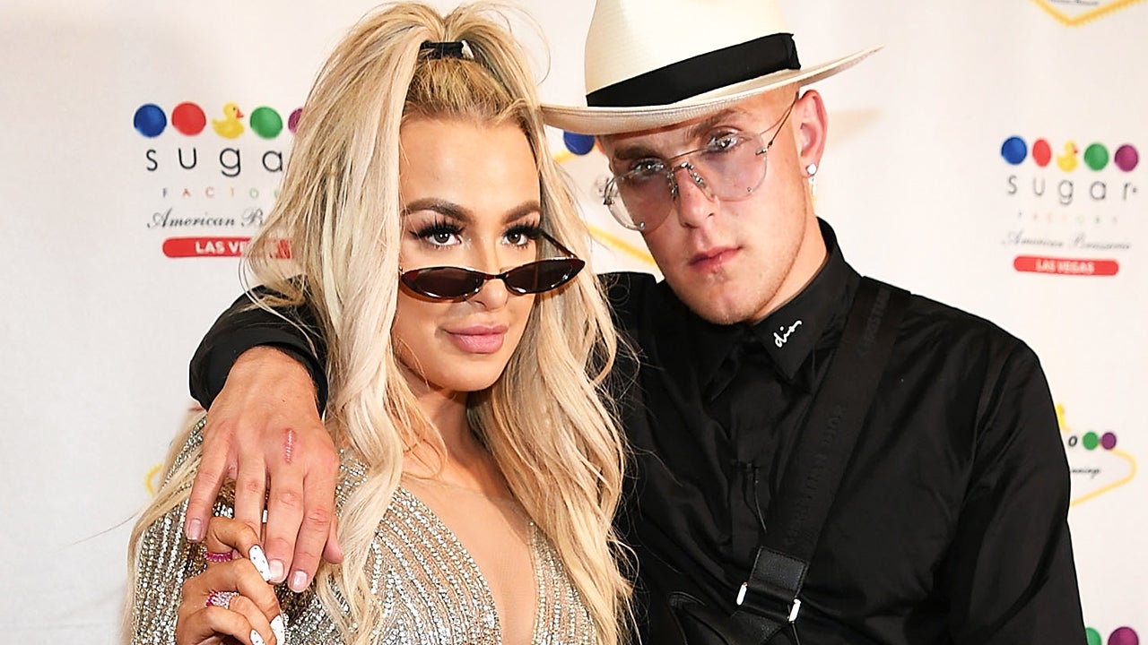 jake with his hand around tanas shoulder posing