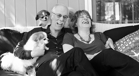 joy and steve on the couch with their 2 dogs