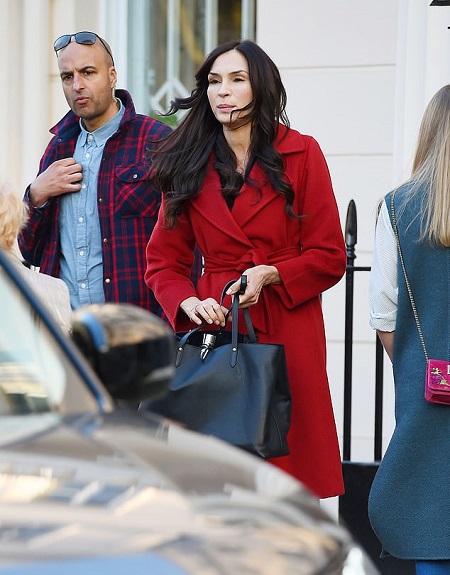 Famke Janssen walking out in the streets to meet a friend.