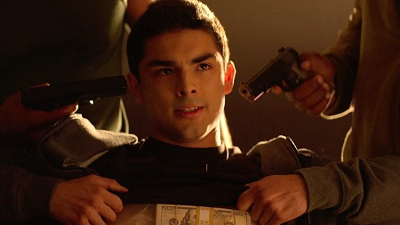 'Cesar' held at gunpoint with stash of money taped to his chest.