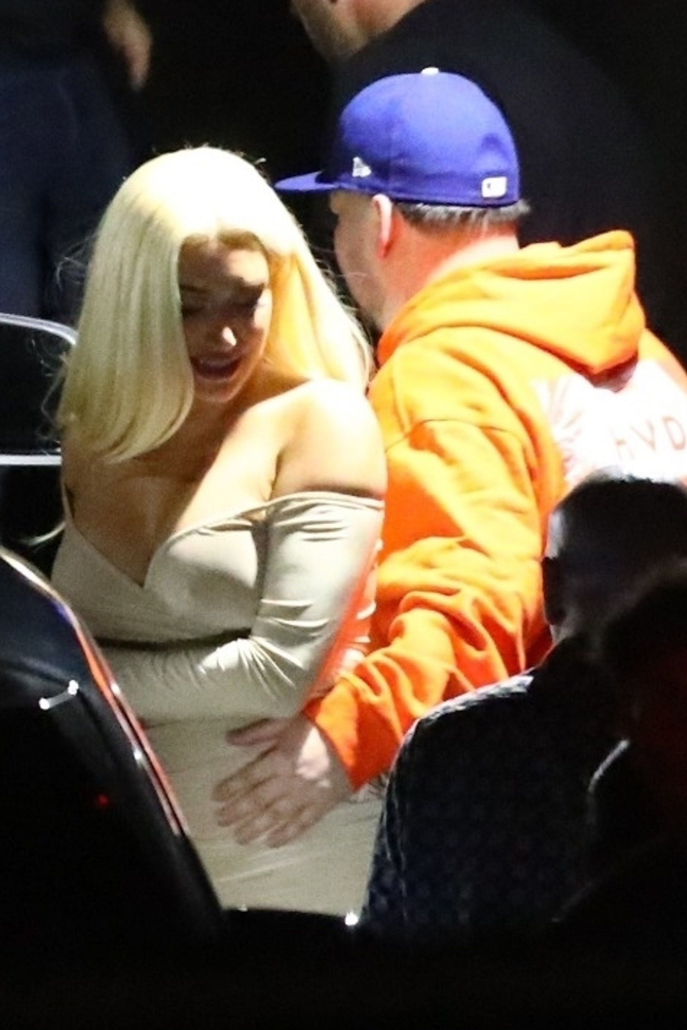 stassie and rob getting in the car, rob touching stassies waist 