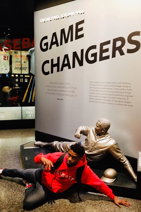 Chadwick Boseman posing in front of a statue just like the statue.