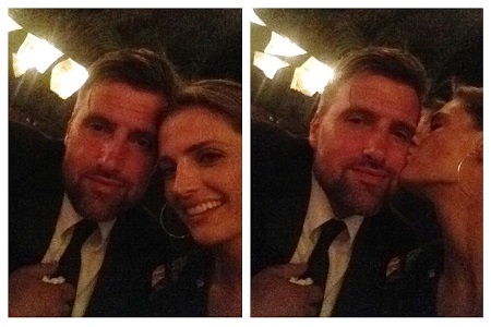 Stana Katic and husband Kris Brkljac being kissed by Stana on the chee.