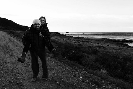 Stana Katic and husband Kris Brkljac carrying her on his back.