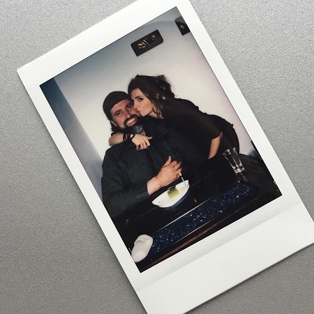 Stana Katic and husband Kris Brkljac kissing her.