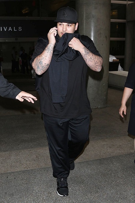 Rob Kardashian talking on the phone.