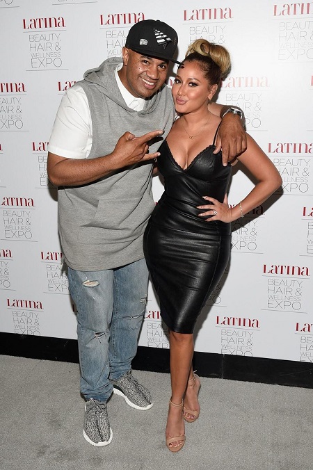 Adrienne Bailon's ex-fiance Lenny Santiago with his one arm around her.