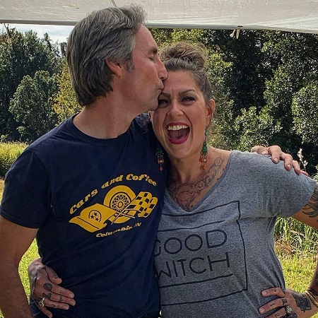 Mike Wolfe kissing the forehead of Danielle Colby.