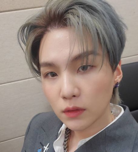 Suga, a member of the global K-pop phenomenon BTS, tested positive for the coronavirus on Friday.