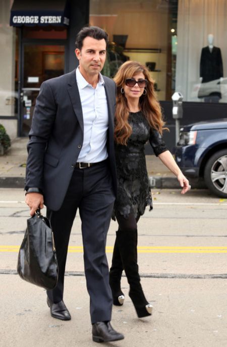 Paula and Jon Caprio walking out of shop holding hand